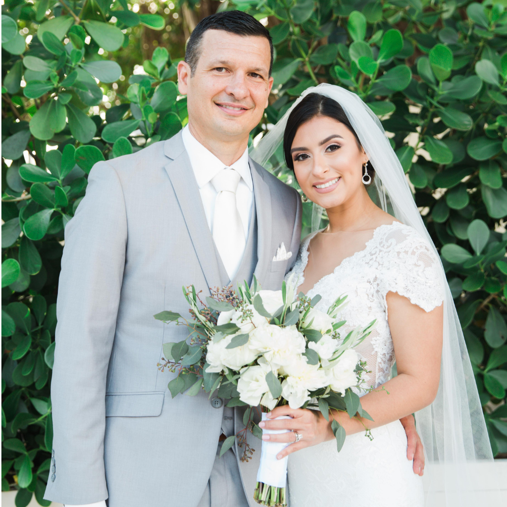 bride and groom smile at coral gables country club