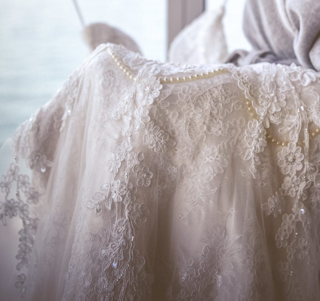 The bride wanted something special to honor her late grandmother, so she sewed pearls onto her Eve of Milady wedding gown