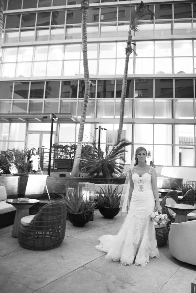 The bride strikes a pose in her Eve of Milady wedding dress in the Eden Roc hotel in Miami Beach