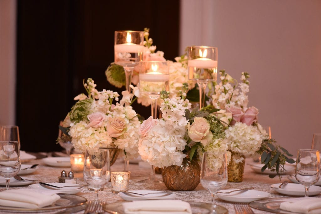 The simple and low centerpieces from Petal Productions featured mercury votives, floating candles, and lots of blush and white florals