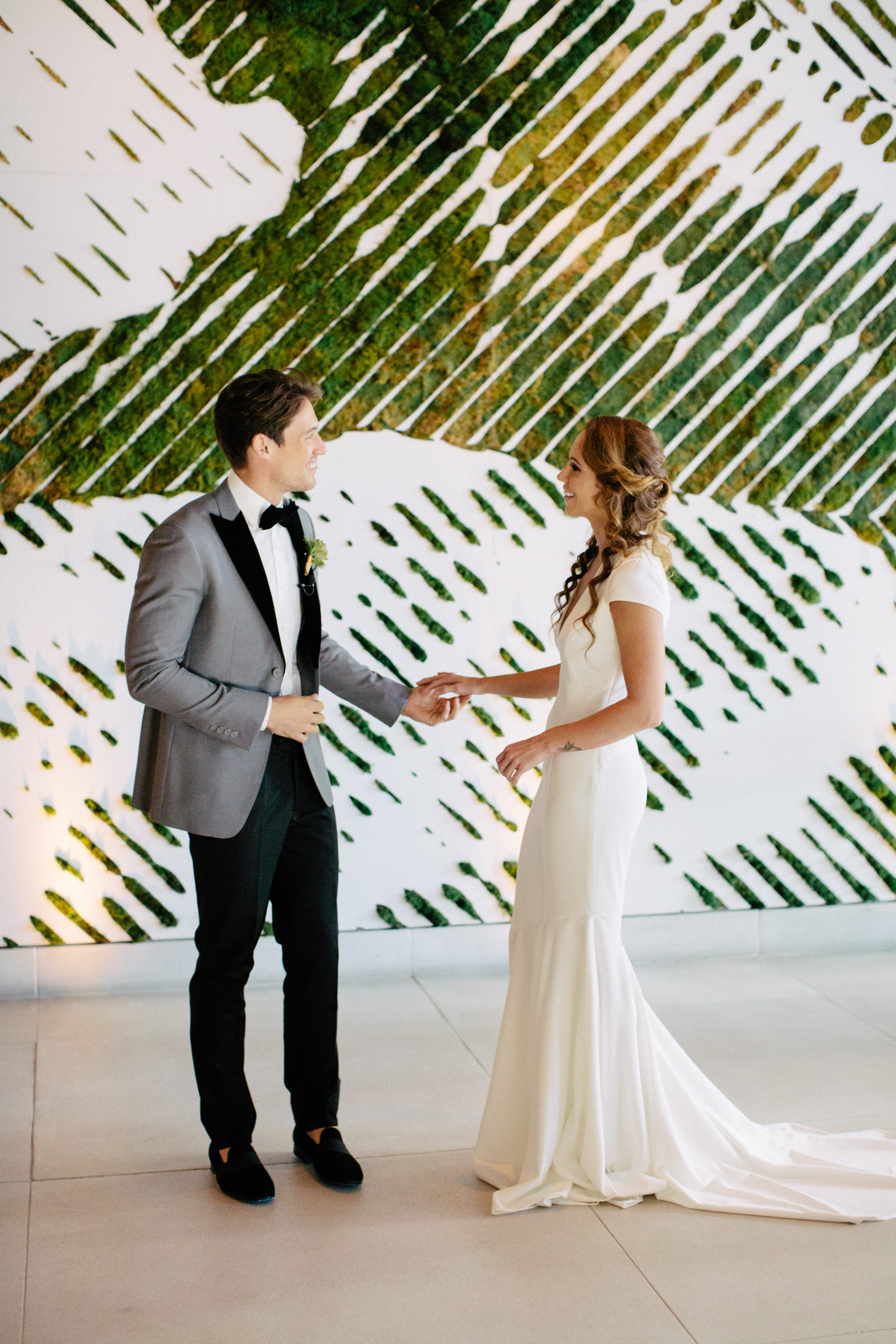 The greenery wall in the lobby of the 1 Hotel South Beach provides a one-of-a-kind backdrop for your first look wedding photos!