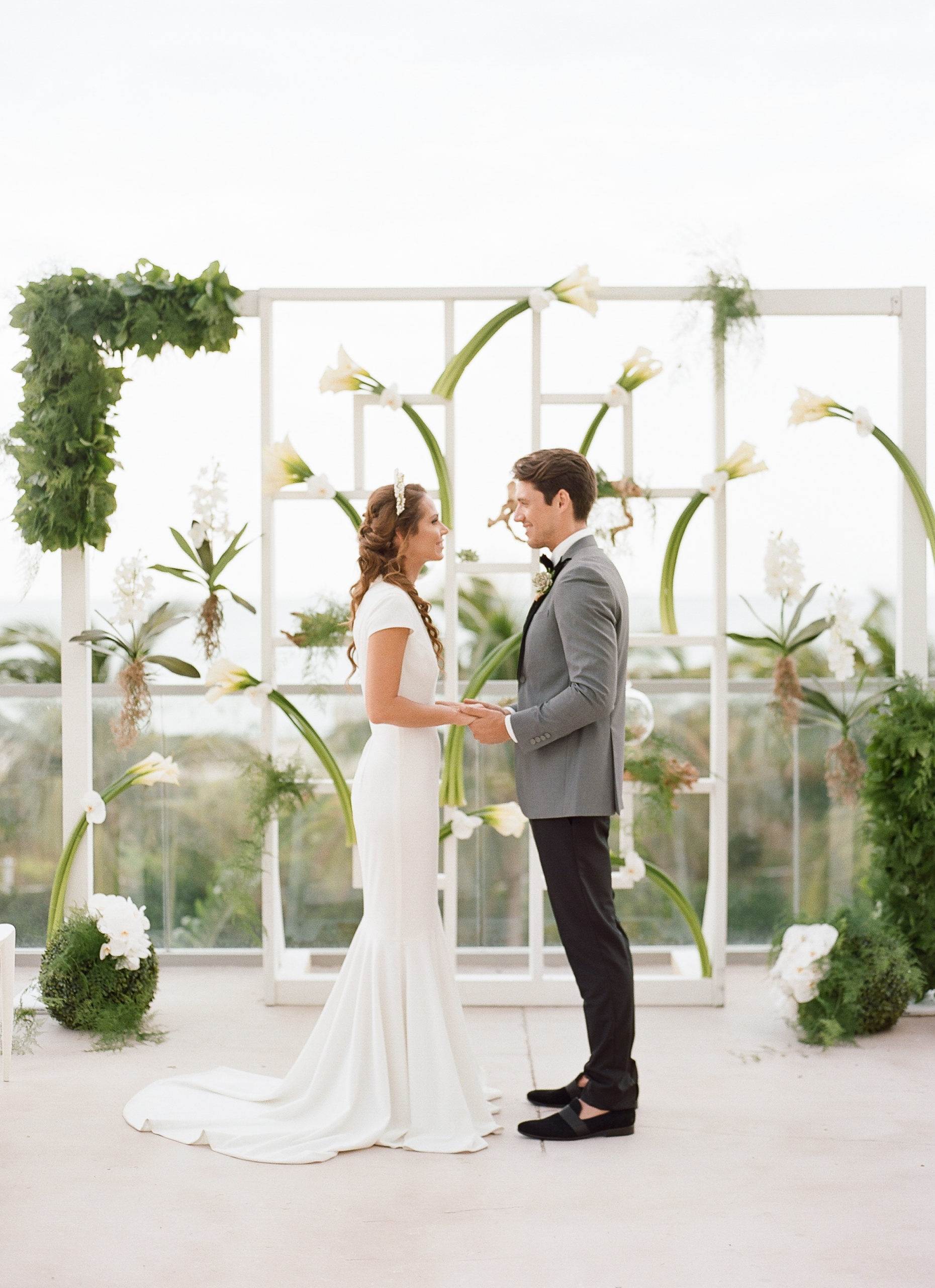 We created a truly unique wedding ceremony structure that incorporated calla lillies, orchids, and lots of greenery. The bride and groom married at the 1 Hotel terrace under the early evening sunset. | 1 Hotel wedding