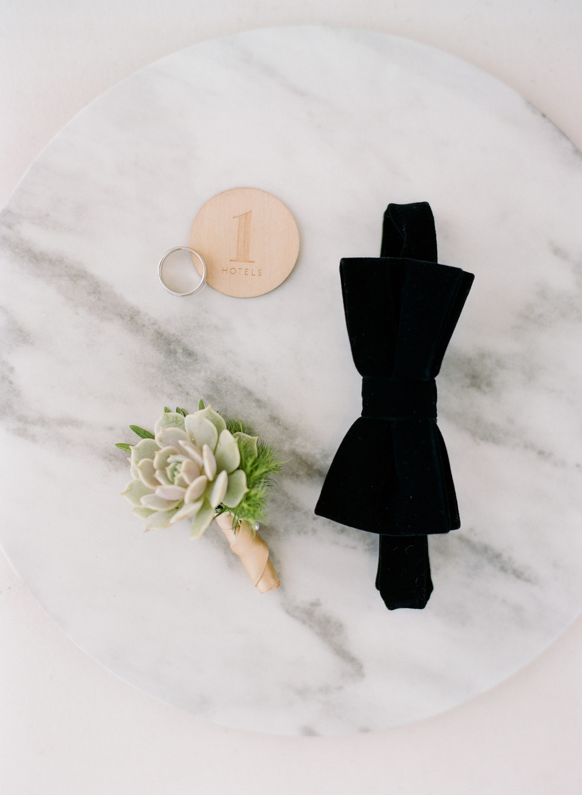 A succulent boutonnière and black velvet tie from Satori Amici were the perfect compliments to the 1 Hotel Room South Beach room key
