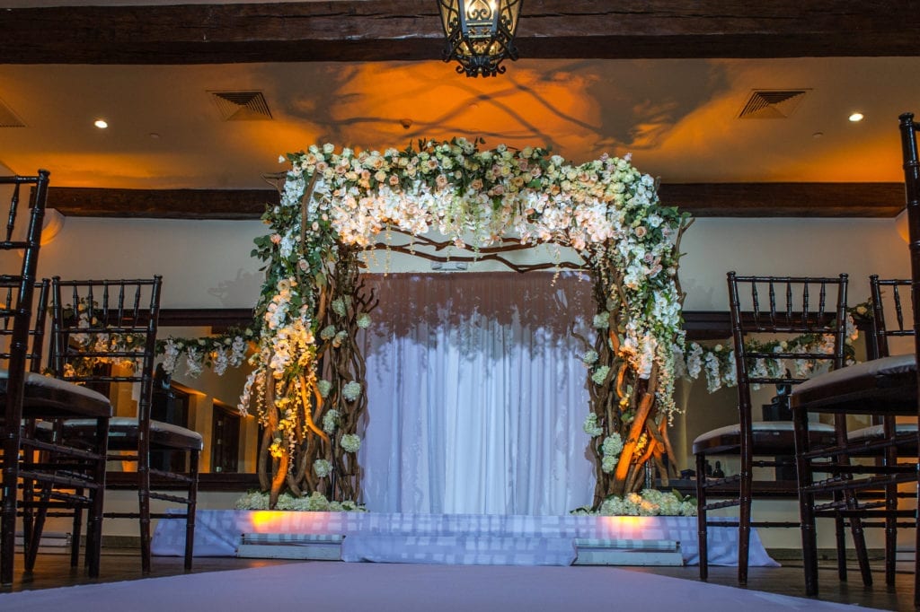 The Bath Club ceremony featured hanging greenery on a ghostwood structure with orchids
