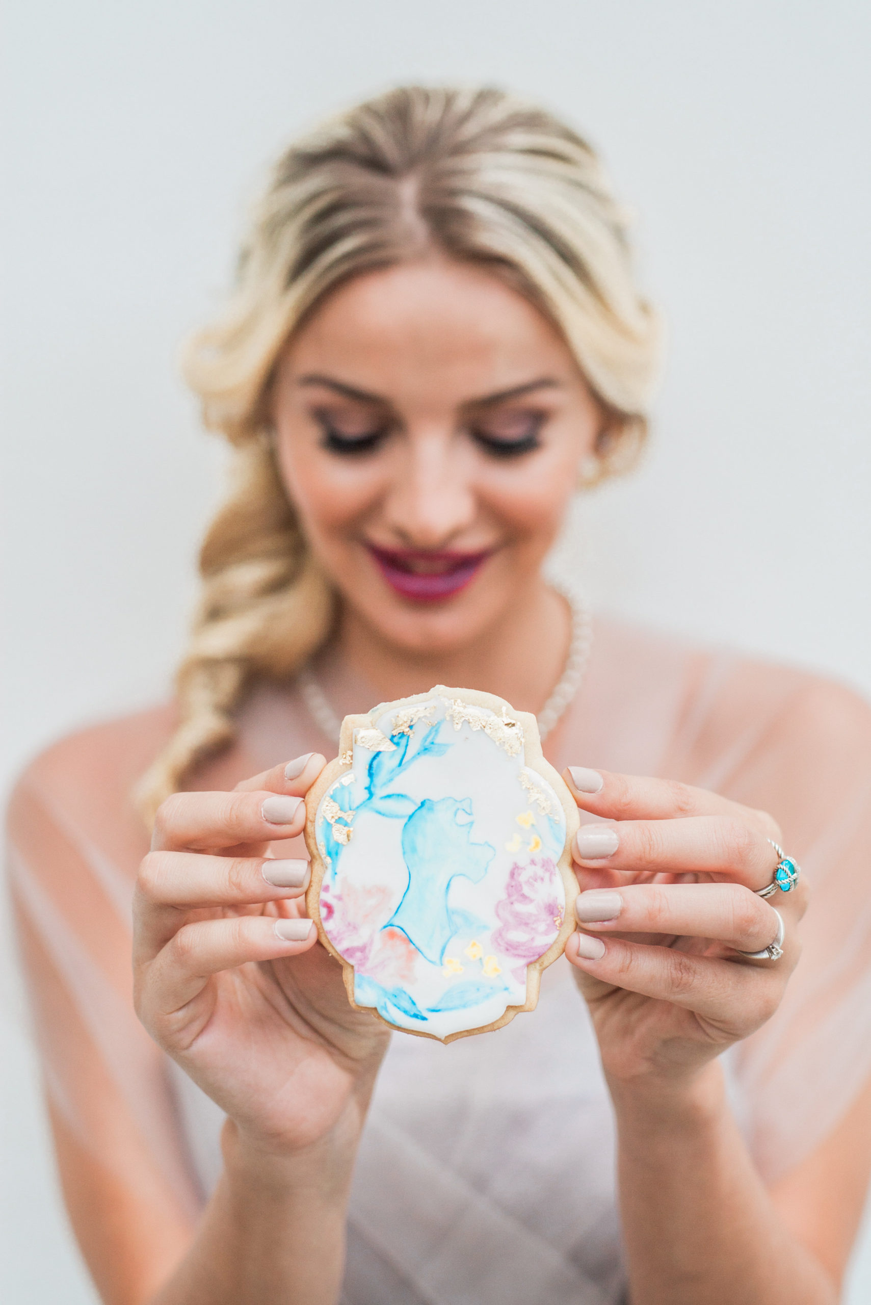 The Lady and the Tramp wedding included watercolor hand painted cookies that mirrored the watercolor invitations and colors as well