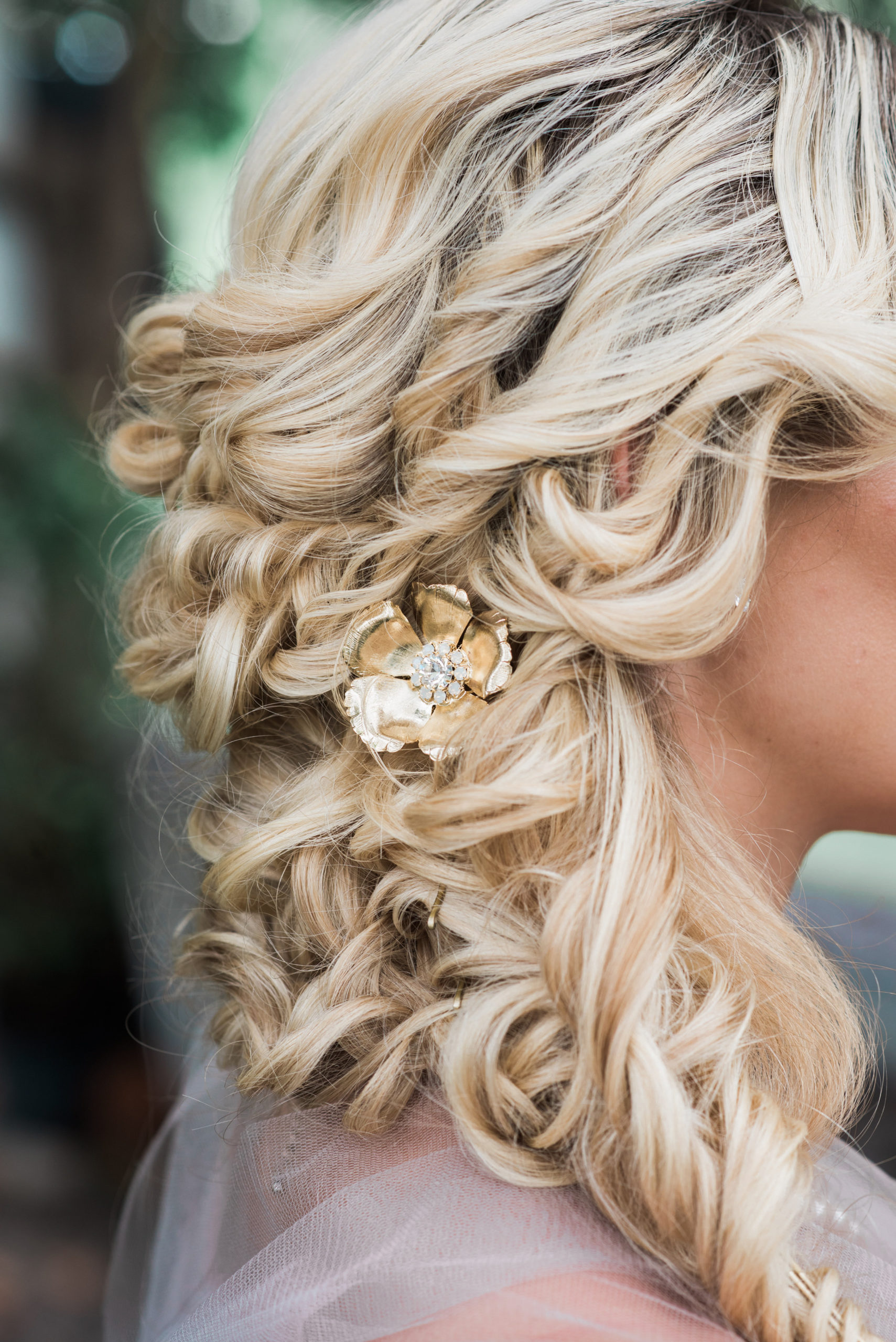 The bride's wedding hair style was tight overlapping curls off to the side, while her face was framed with loose pieces | wedding hair, wedding updo, curled hair