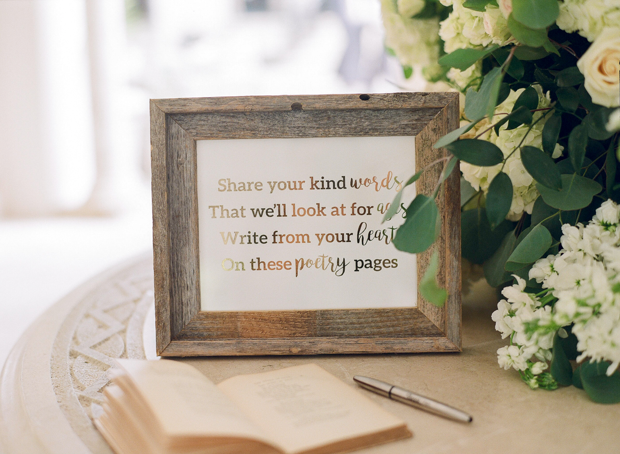 The wedding sign in book was an antique poetry book where guests would write their words of wisdom and well wishes for the bride and groom