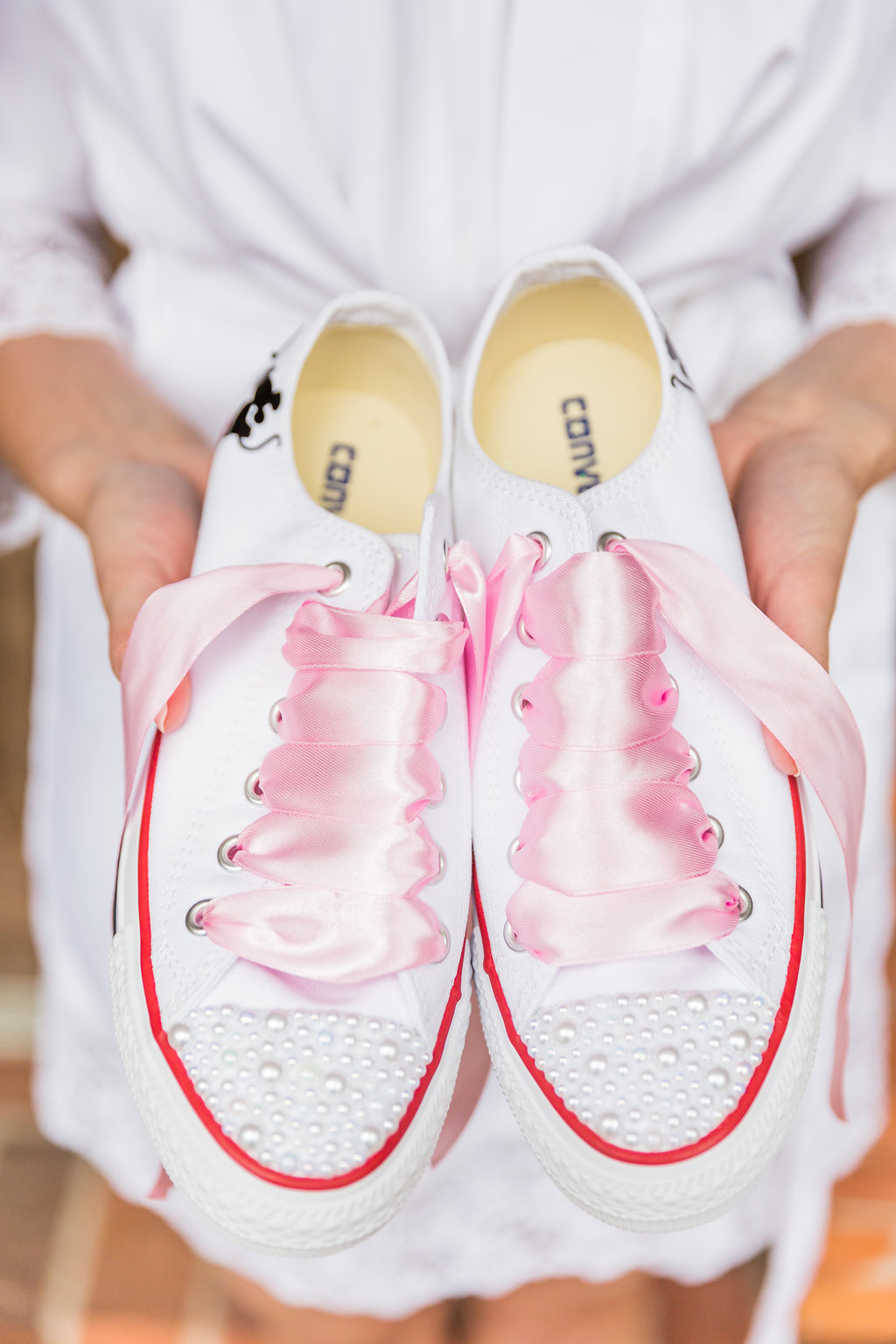 The bride wore custom Team Bride socks with pink satin lace bedazzled converse sneakers