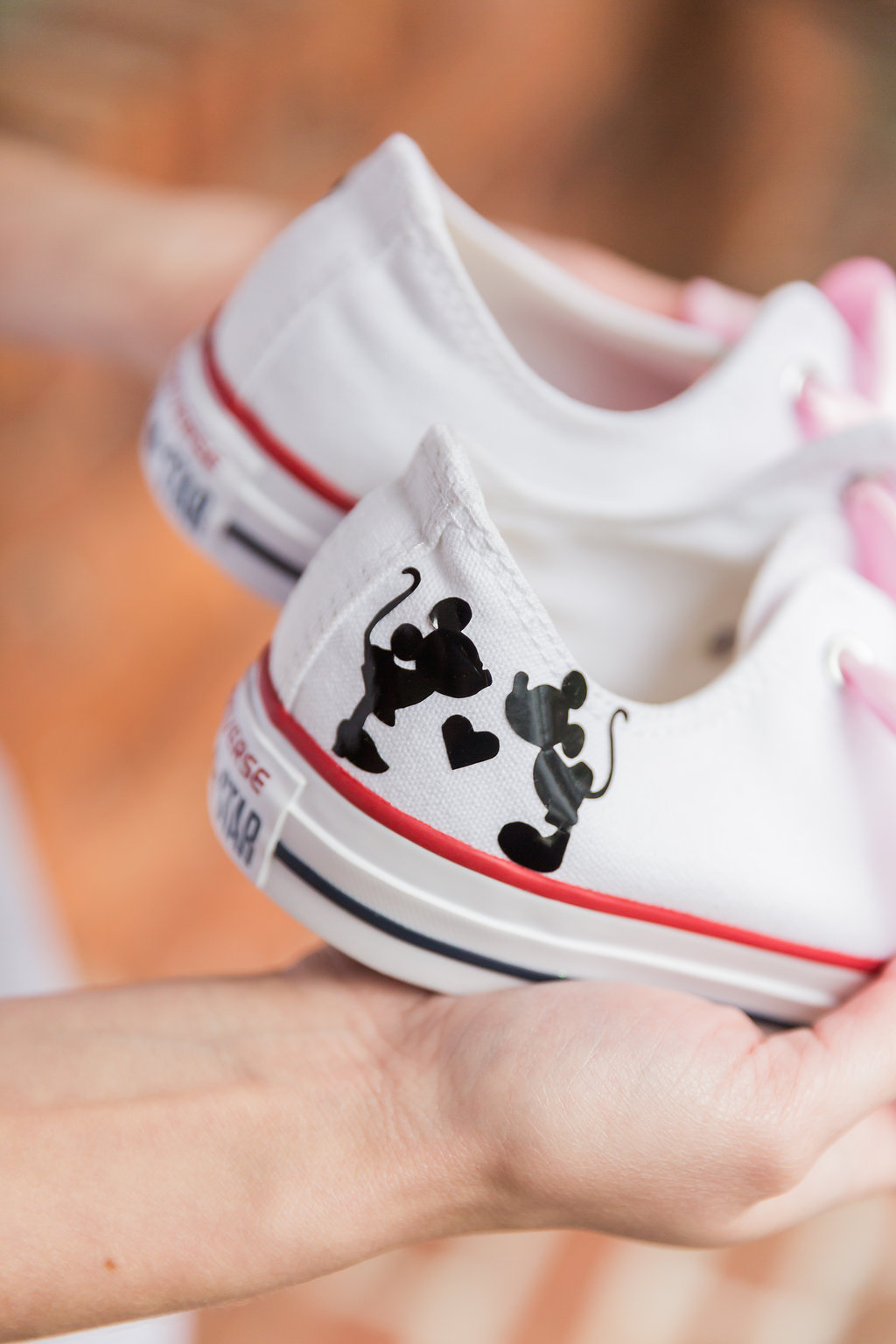 The Disney loving bride wrote her groom's name on the bottom of her converse sneakers, while the opposite shoe had a silhouette of Mickey and Minnie kissing