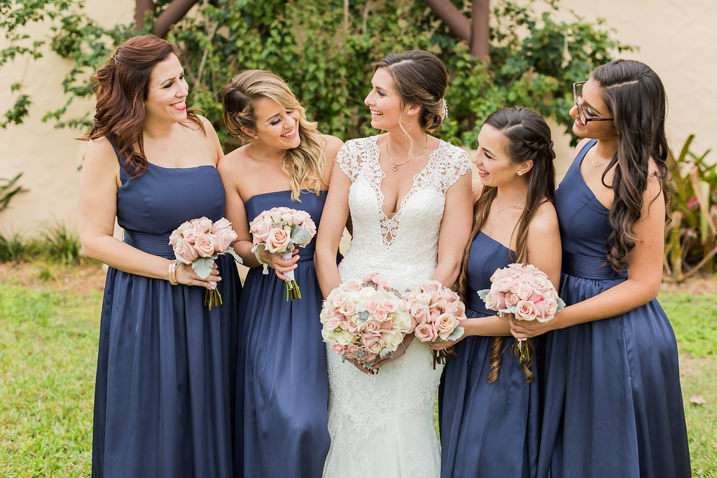 The bridesmaids wore navy dresses in off the shoulder and strapless