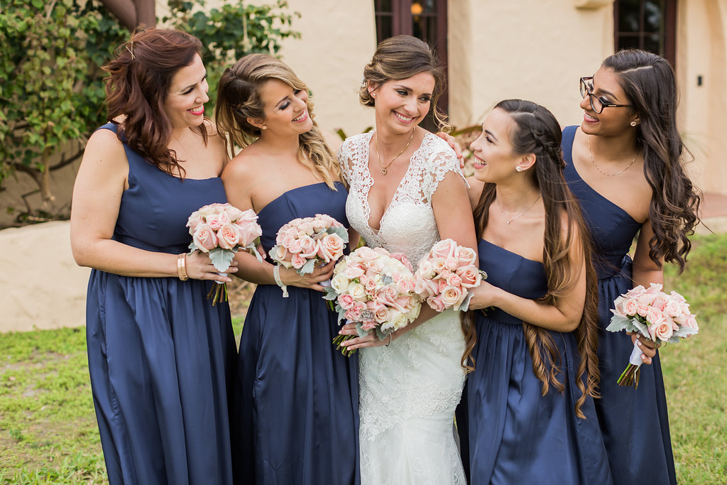 The bridesmaids wore navy dresses and held bouquets of lamb's ear and blush roses