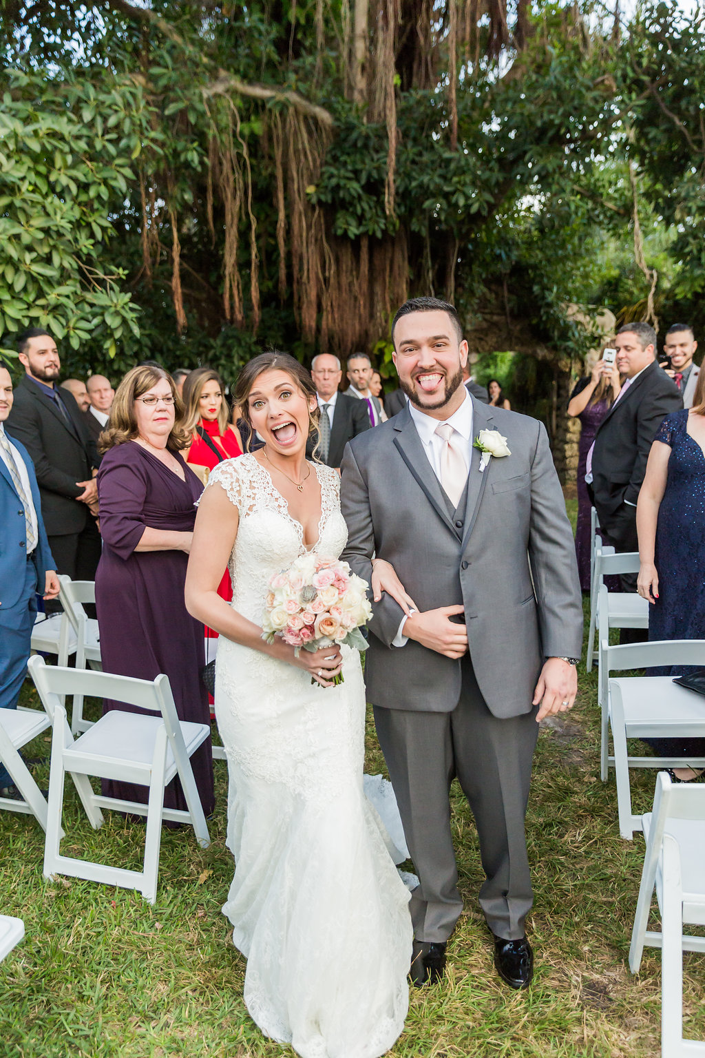 The bride and groom make funny faces after the ceremony reflecting their true personalities