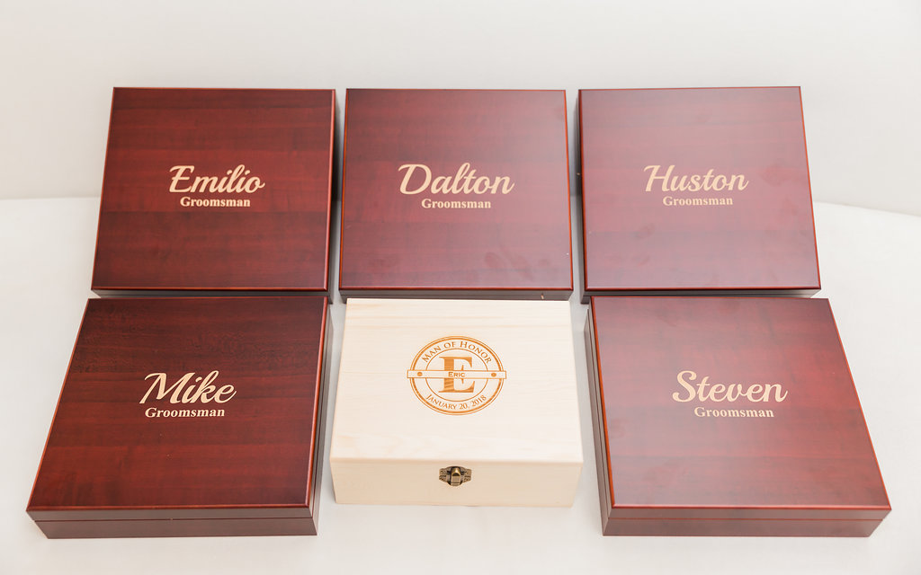 The groom gifted his groomsmen with custom wood boxes filled with a flask, bottle opener, lighter, and pocket knife