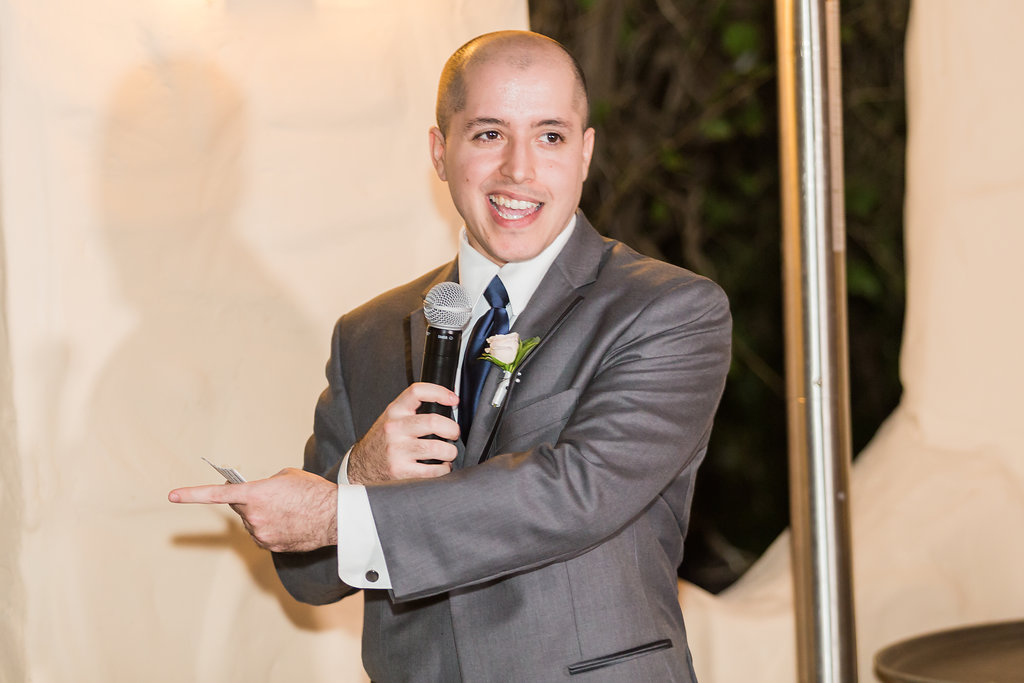 The best man gives his hilarious speech during dinner in the Curtiss Mansion courtyard