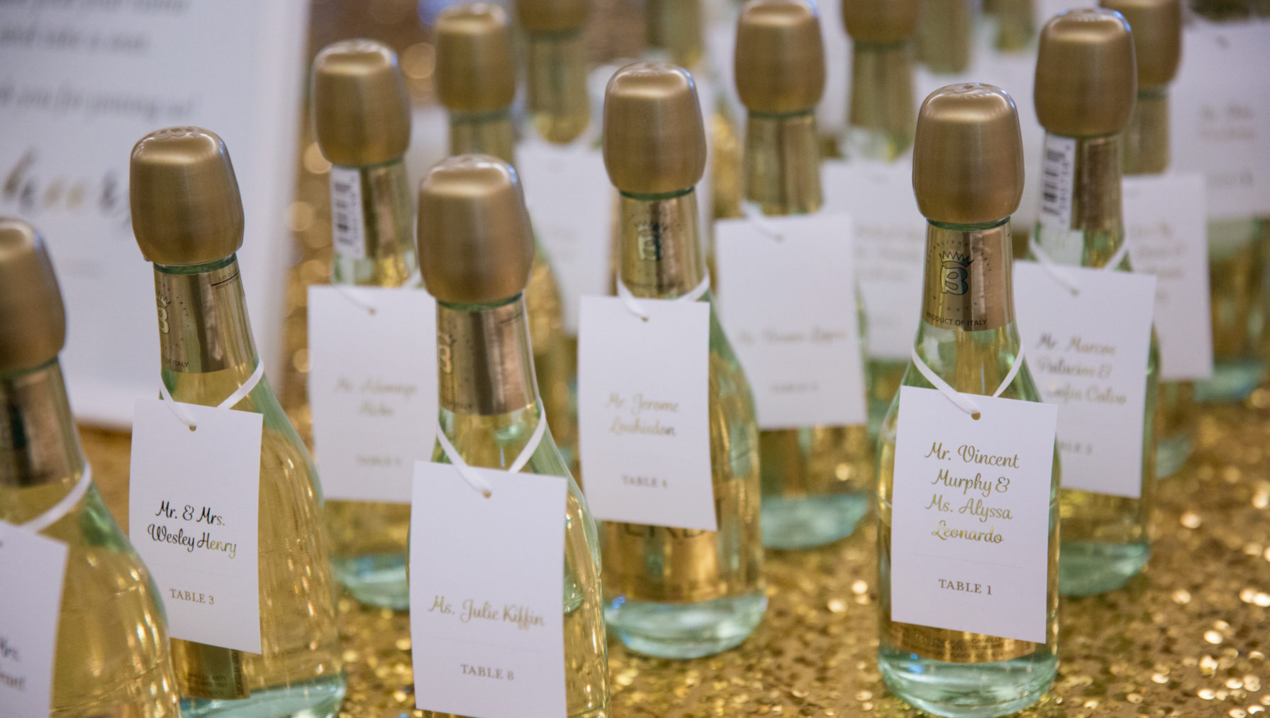 The mini champagne bottles had tags with the guest names and table assignment