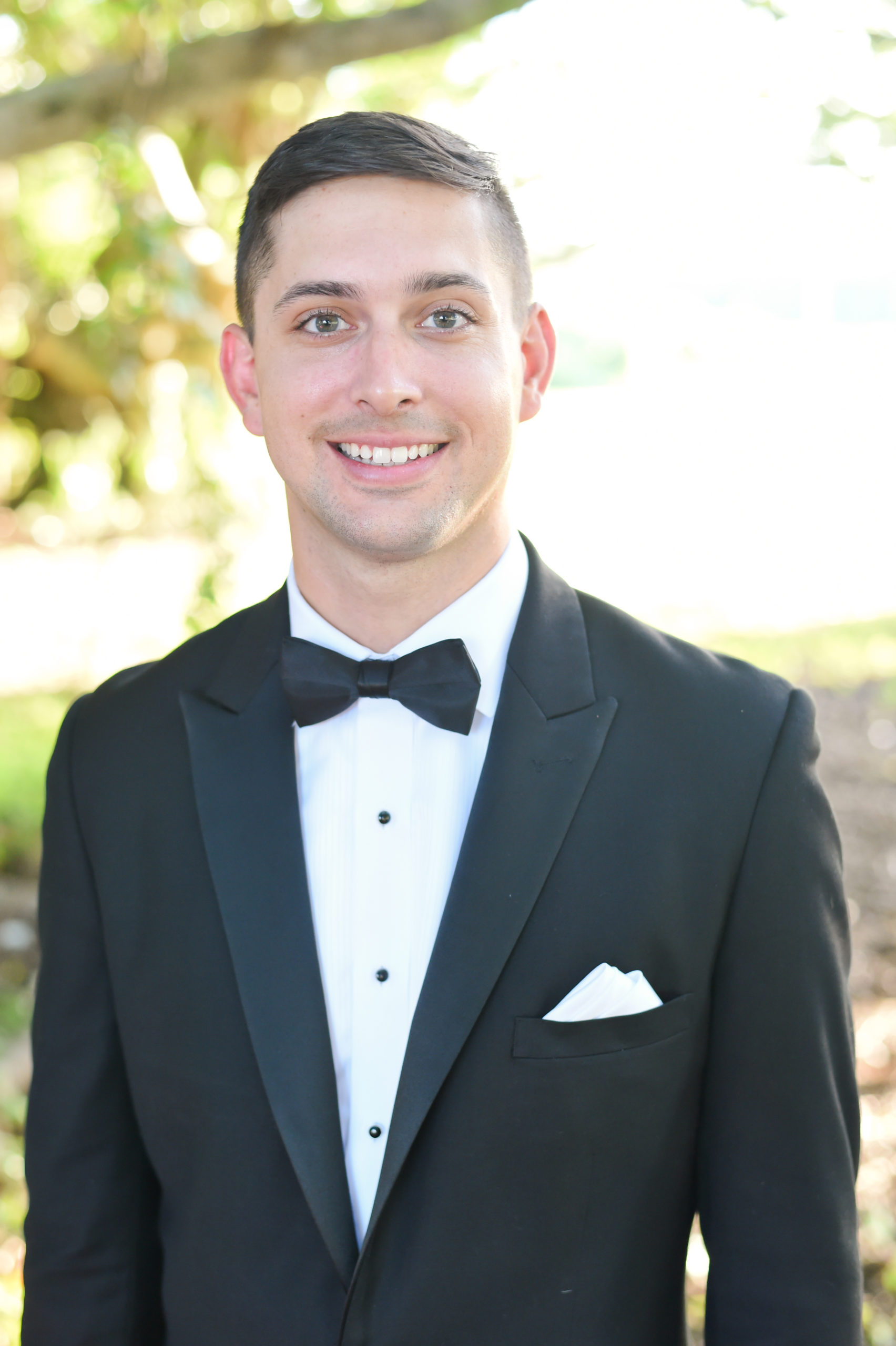 The groom wore a peak lapel tuxedo with black bowtie