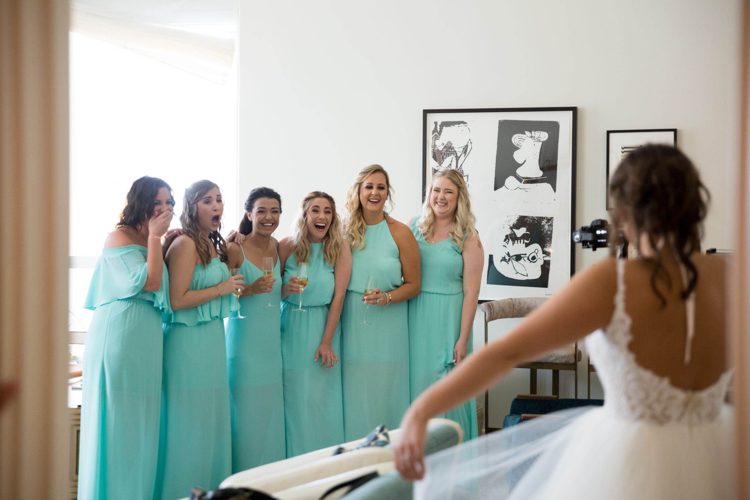 The bride reveals her Hayley Paige wedding dress to her bridesmaids