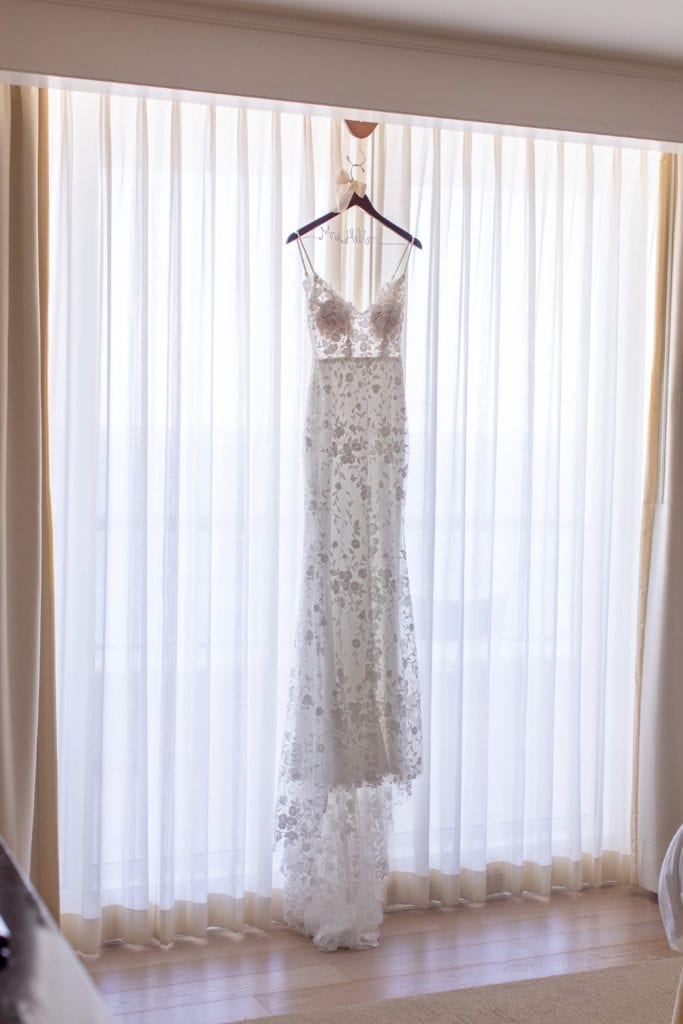 wedding gown hanging on the window