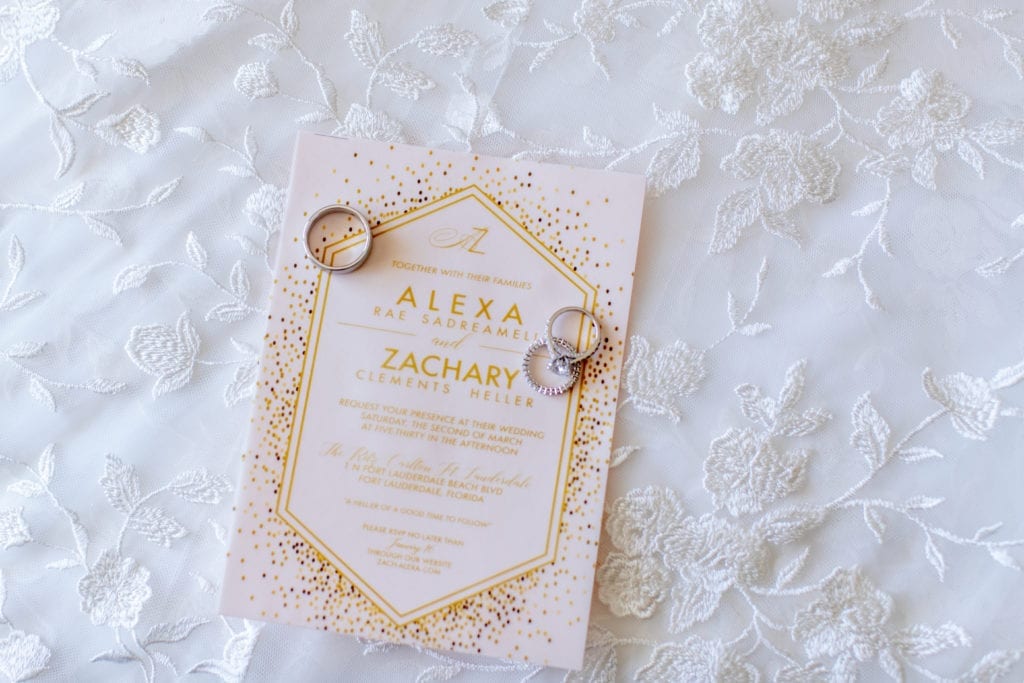 the wedding invitation printed in gold ink on a frosted vellum sheet and backed with a blush cardstock