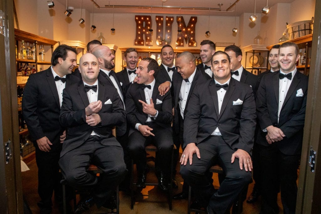 groomsmen laugh and joke in the rum room at Ritz Carlton Ft. Lauderdale