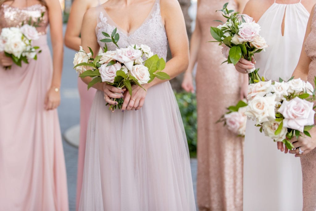 mismatched blush and ivory bridesmaids dresses with rose bouquets