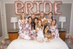 bride poses with her dog on wedding day