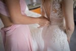 bride getting zipped into her Pronovias wedding gown