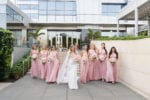 bride and her bridesmaids wearing blush outside four seasons Miami wedding