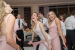 bride dances with one of her bridesmaids