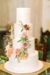 4 tier wedding cake with floral wreath on the front