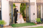 bride and groom strike a funny pose during their wedding entrance at Villa Woodbine