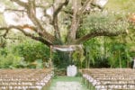 villa woodbine wedding ceremony with a copper arch and bistro lighting