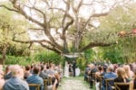 villa woodbine wedding ceremony with bistro lighting and flower petals