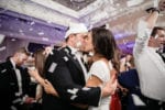 Bride and Groom kiss under the confetti blast during their wedding