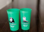 custom green Flannigan's cups featured the bride and groom's faces and wedding details for their wedding