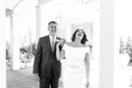 bride laughs as she holds her groom's hand