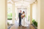 bride and groom pose in lantern lane at LaPlaya Naples, wedding designed by wedding planner Oh My Occasions