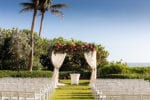 floral draped ceremony structure on the lawn of LaPlaya Naples