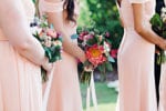 blush bridesmaids dresses with colorful fuschia bouquets