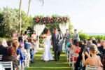 bride and groom leave their ceremony on the La Playa Naples lawn