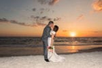 bride and groom kiss as the sun sets at La Playa Naples