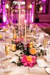 pink flowers and taper candles on a gold linen