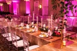 long royal table in a T-shape with gold linen