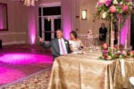 bride and groom smile during the toasts at their gold table at La Playa Naples
