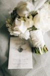 white peony and rose bouquet with a wax seal vellum wedding invitation