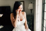 bride tears up as she sees herself in a wedding gown