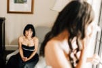 mother of the bride tearfully admires her daughter in a wedding gown