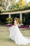 bride holds her horsehair dress in the Frenchman's Reserve garden