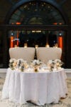 sweetheart table half moon with tall ivory chairs