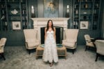 bride stands in the library at Frenchman's Reserve Country Club in her second dress of the night